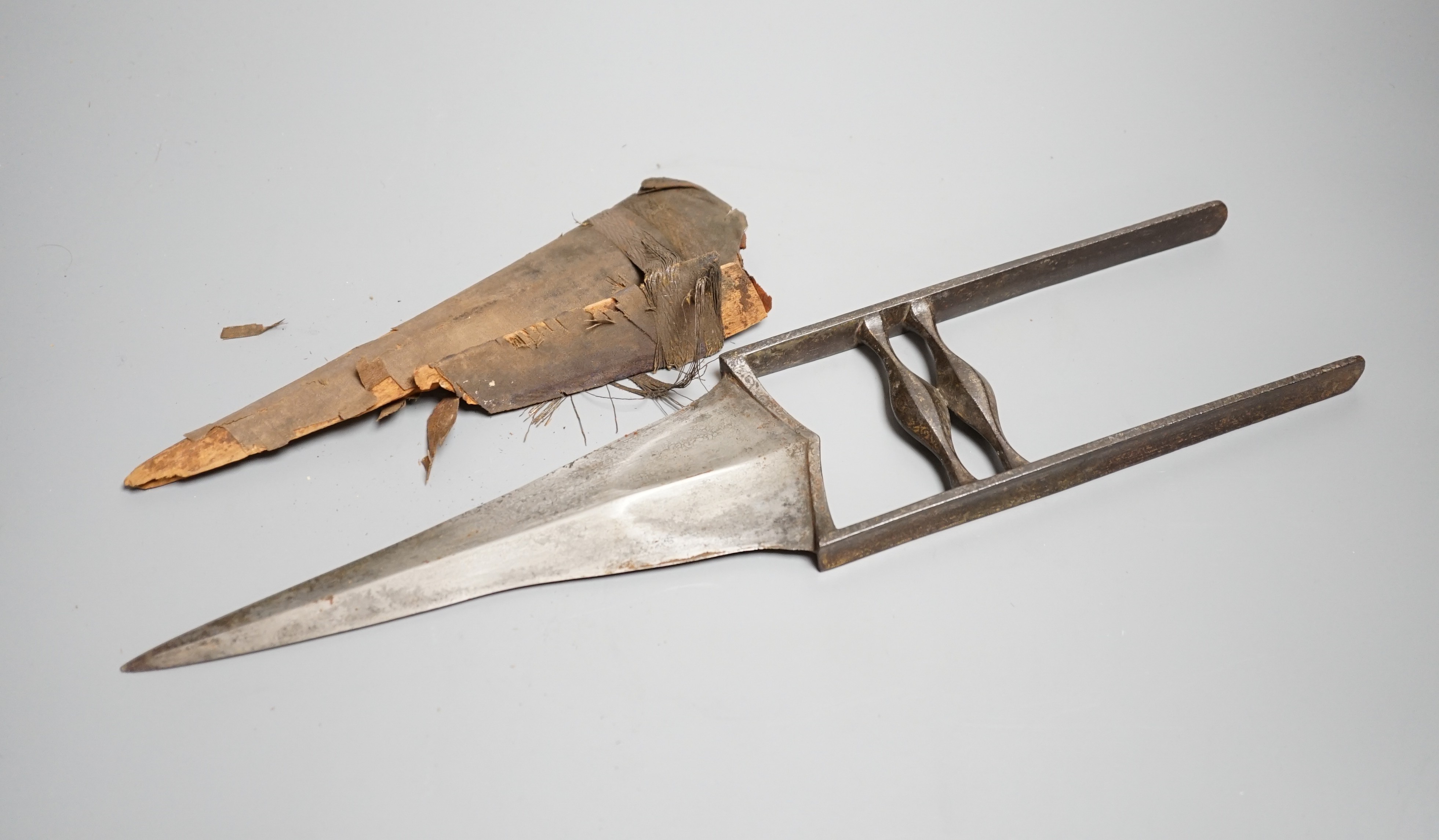An Indian dagger katar c.1800, swollen blade, hilt retains traces of koftgari decoration, in its velvet covered sheath (worn). Length 39cms.